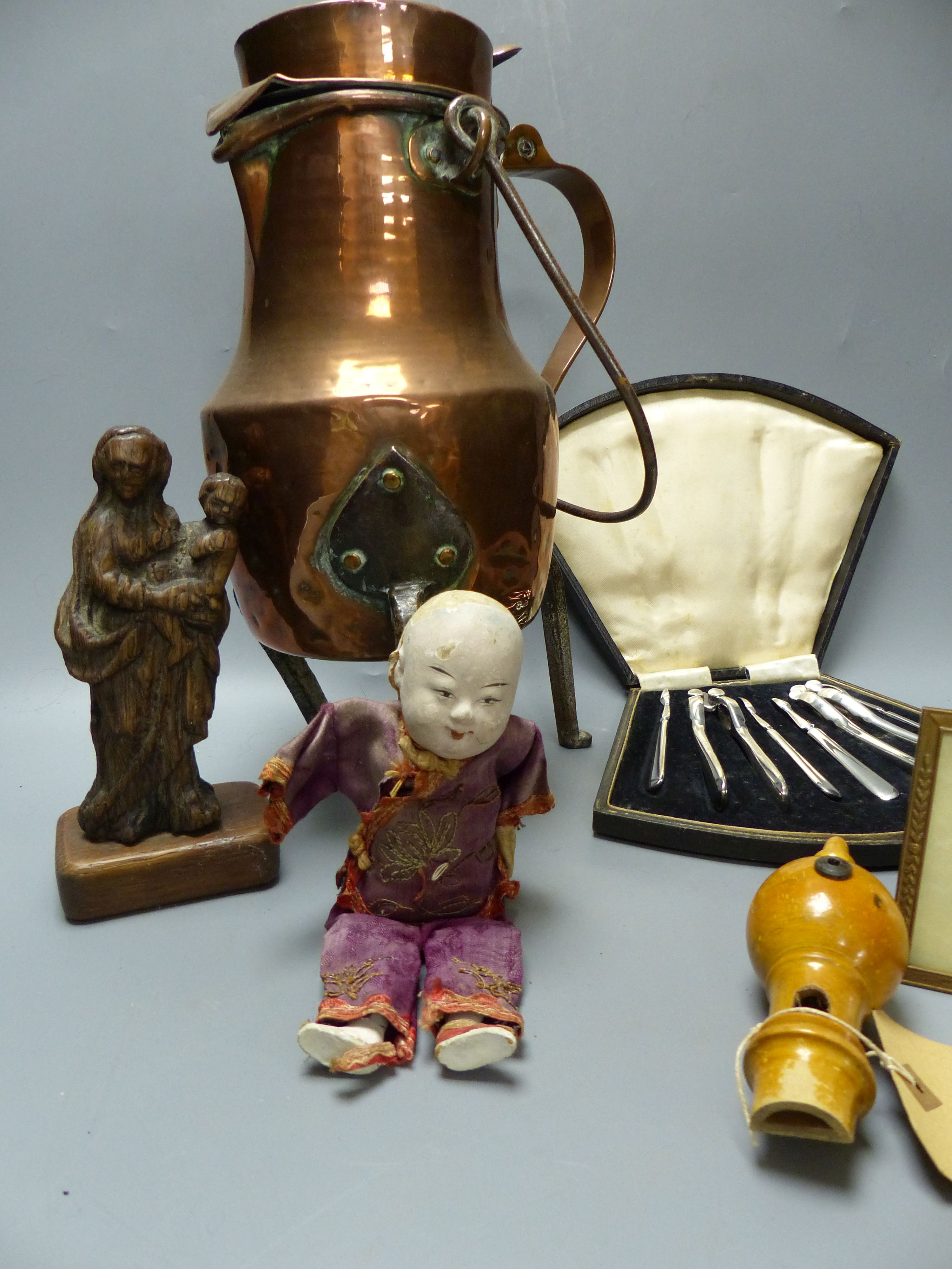 A quantity of mixed collectables including an oval mahogany tray, a lidded copper vessel, a Chinese doll, a treen whistle etc.
